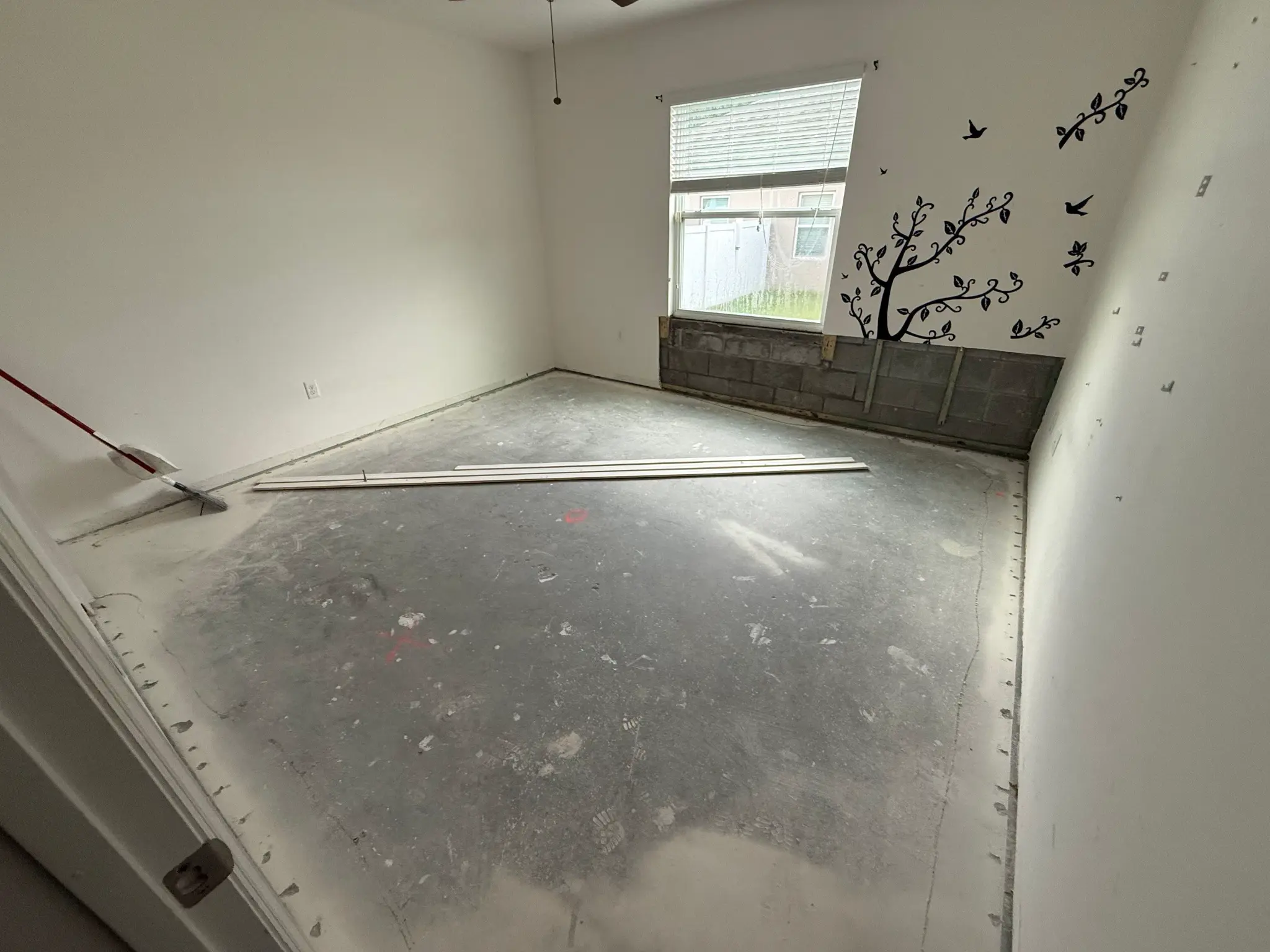 Before flooring transformation: Unfinished concrete subfloor
